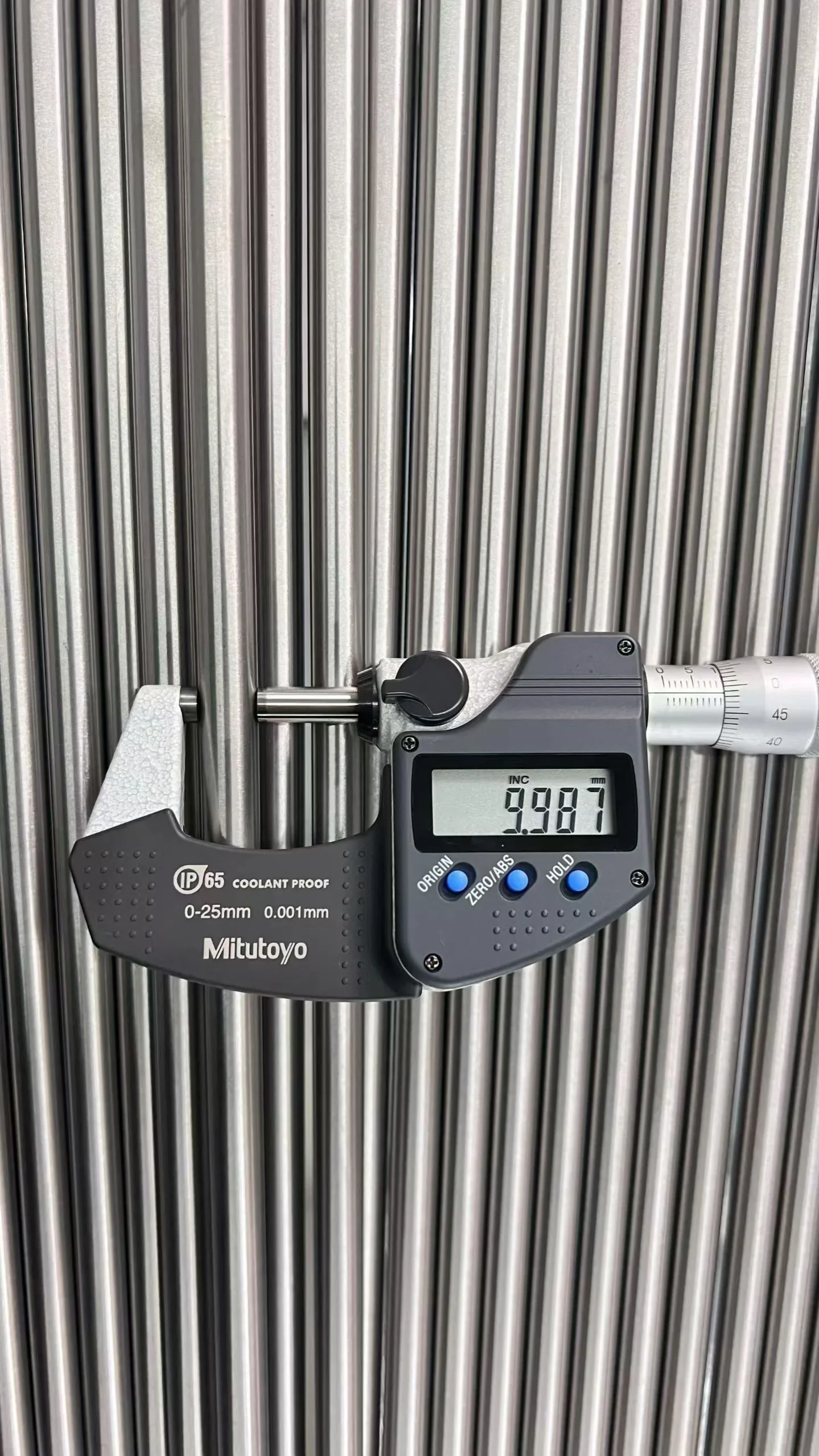 What is a Titanium Rod Used For? (Grades, Standards & Applications Guide) 3 Technician checking the h7 diameter tolerance of a precision titanium rod with a micrometer.