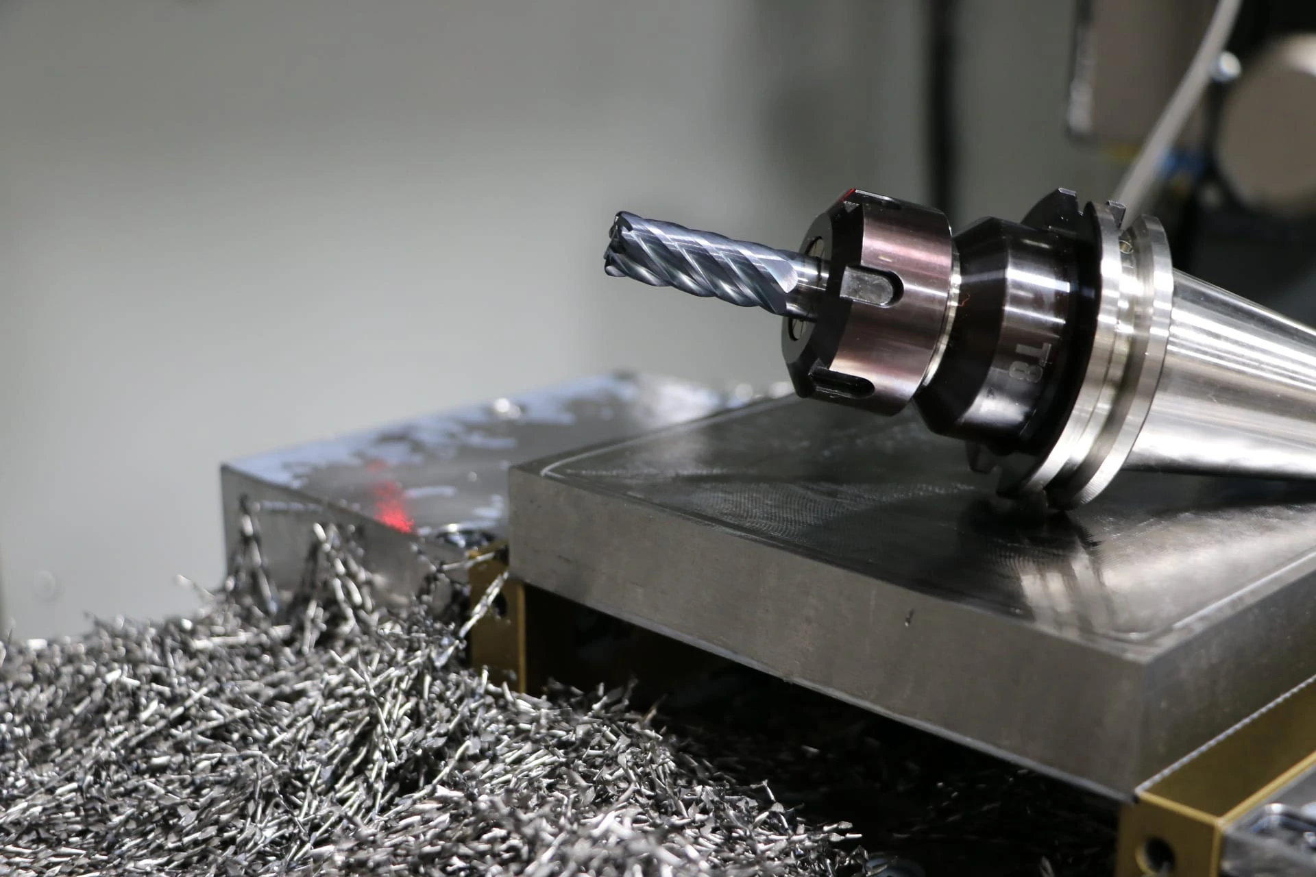 5 Proven Tips for CNC Machining Titanium Without Breaking Tools 1 Close-up of CNC end mill machining titanium aerospace part with coolant.