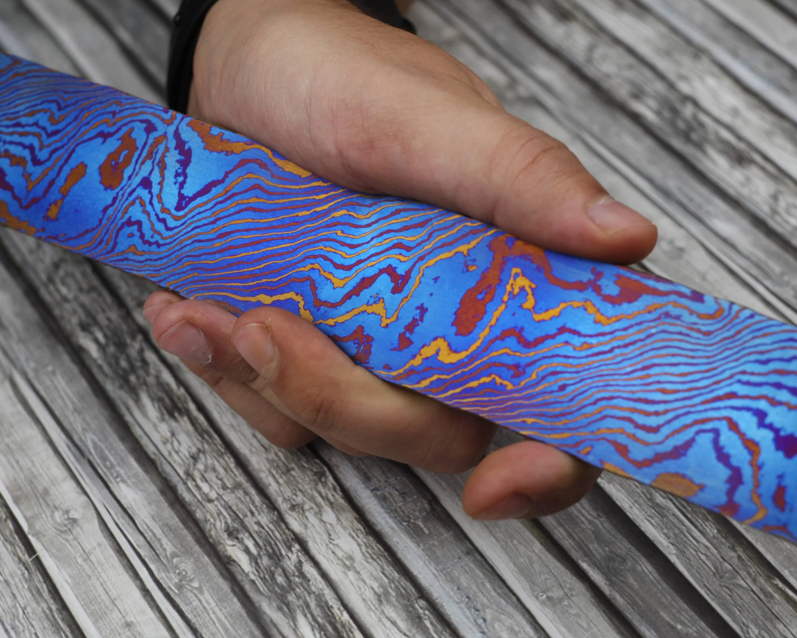 What is Titanium Damascus? The Ultimate Guide to Composition, Colors, and Uses 1 Close-up macro shot of blue and purple Titanium Damascus pattern.