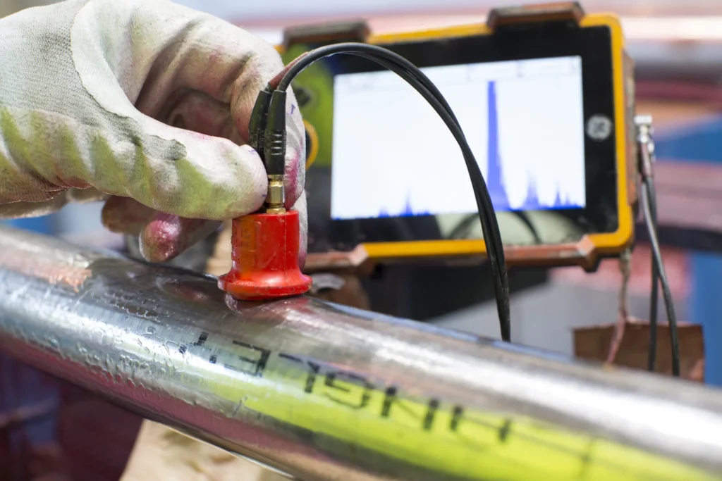 Seamless vs. Welded Titanium Tube: Which Is the Best Choice for Your Project? 2 Engineer performing 100% ultrasonic testing on a medical grade titanium round bar to ensure zero internal defects
