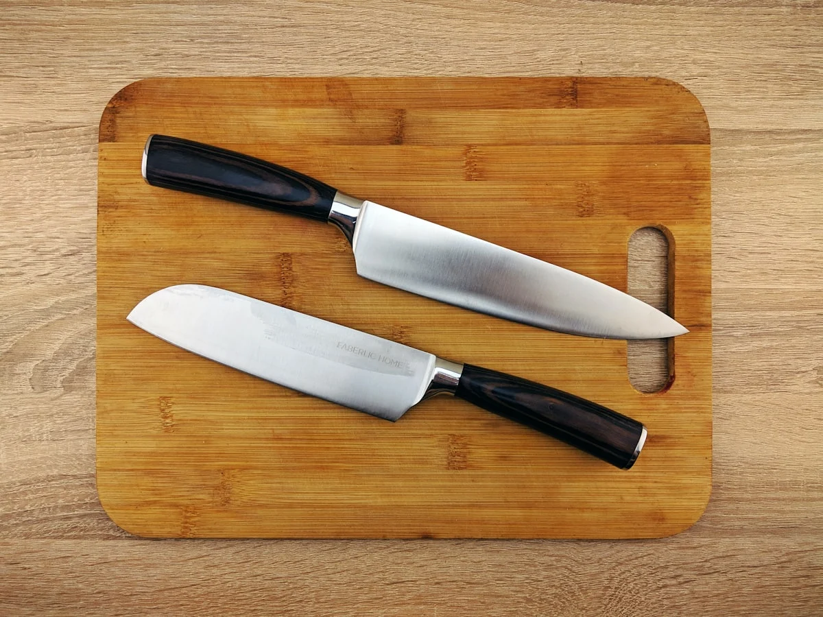 Titanium vs Wood Cutting Board: What Independent Tests Actually Show 1 Knives and cutting board on a metal surface - titanium cutting board kitchen setup
