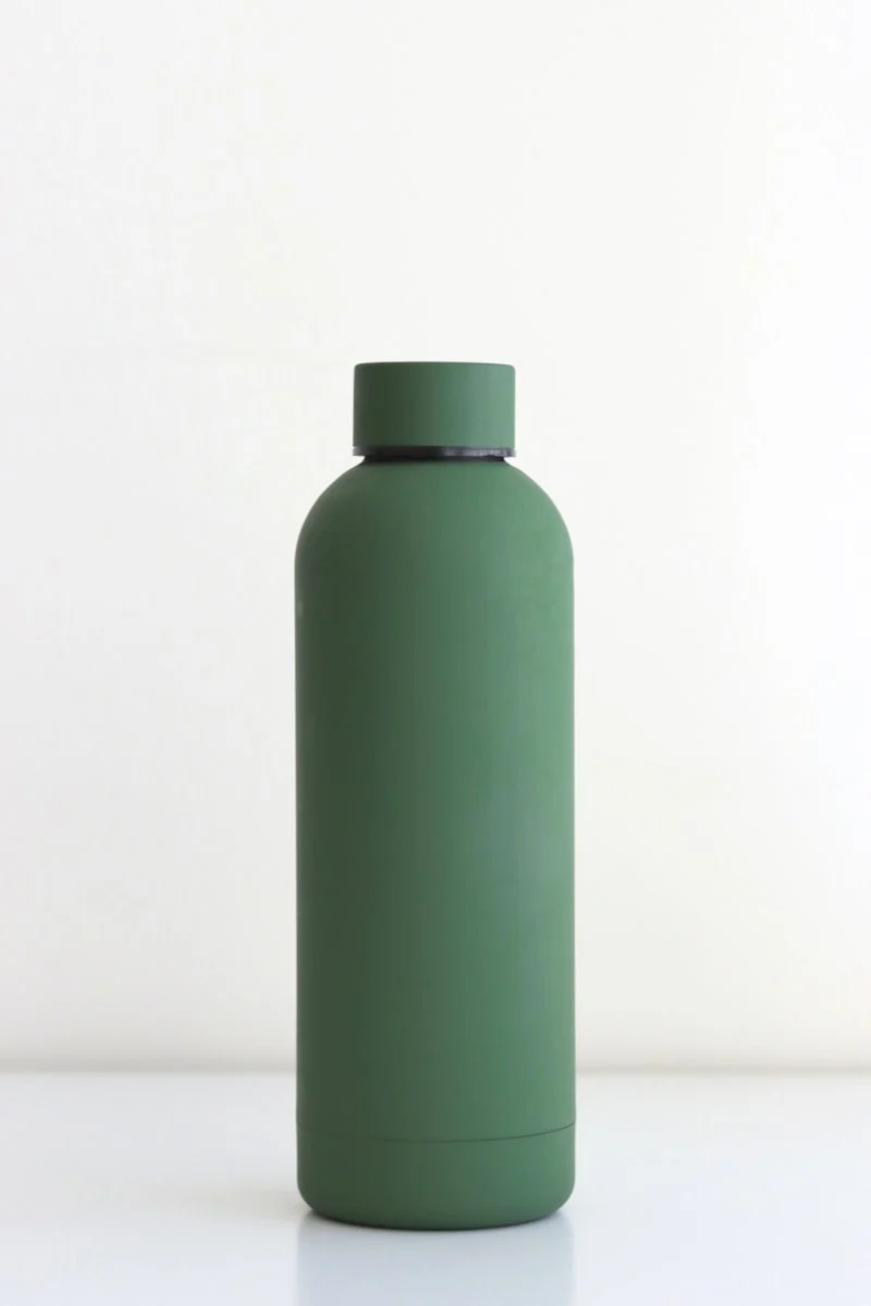 Titanium Water Bottle Pros and Cons in 2026: I Tested 5 Brands to See If They’re Worth the Price 1 Titanium water bottle held in hand outdoors - demonstrating lightweight design