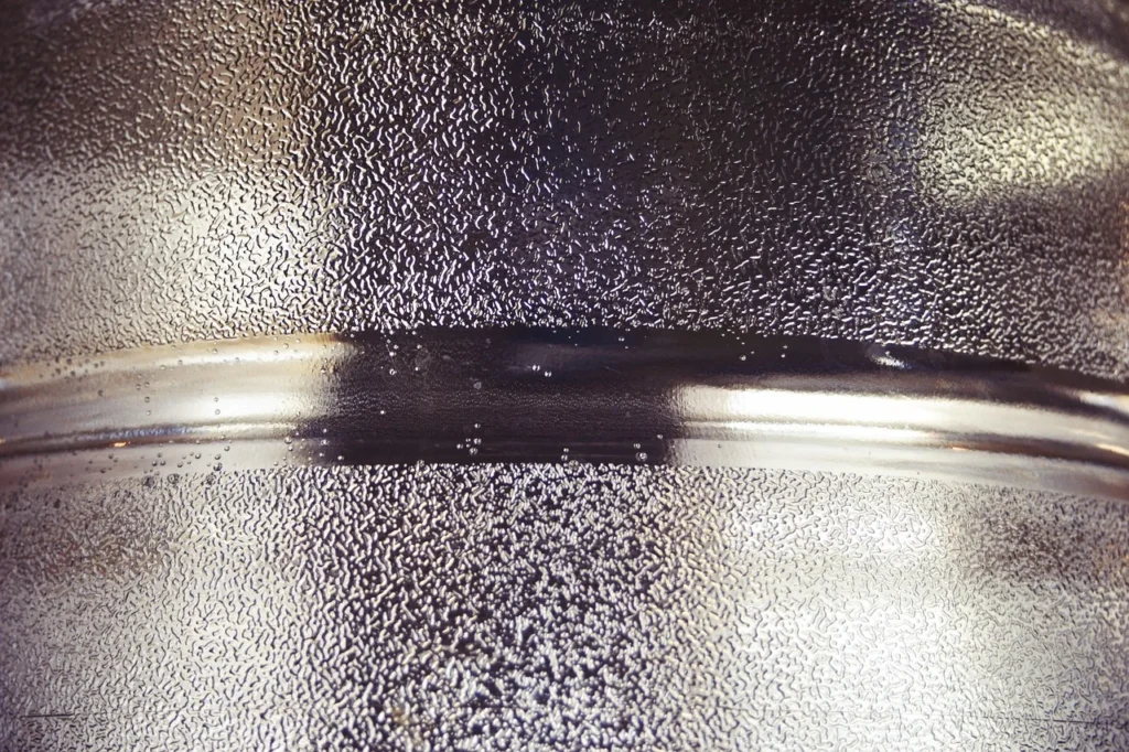 How to Polish Titanium to a Mirror Finish: Grit Sequence, Compounds, and Common Mistakes 1 Highly polished metal surface with clear mirror-like reflection - titanium mirror finish result