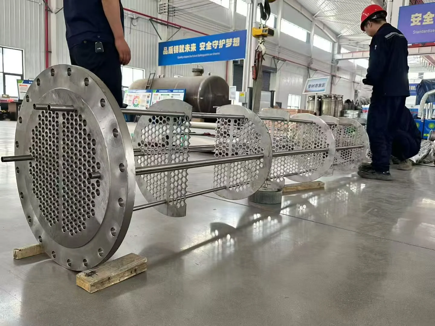 Titanium Seamless Tube Buying Guide: ASTM B338 Specs, Grade Selection, and How to Order Right 4 Shell and tube heat exchanger titanium tube bundle machining process - industrial manufacturing facility